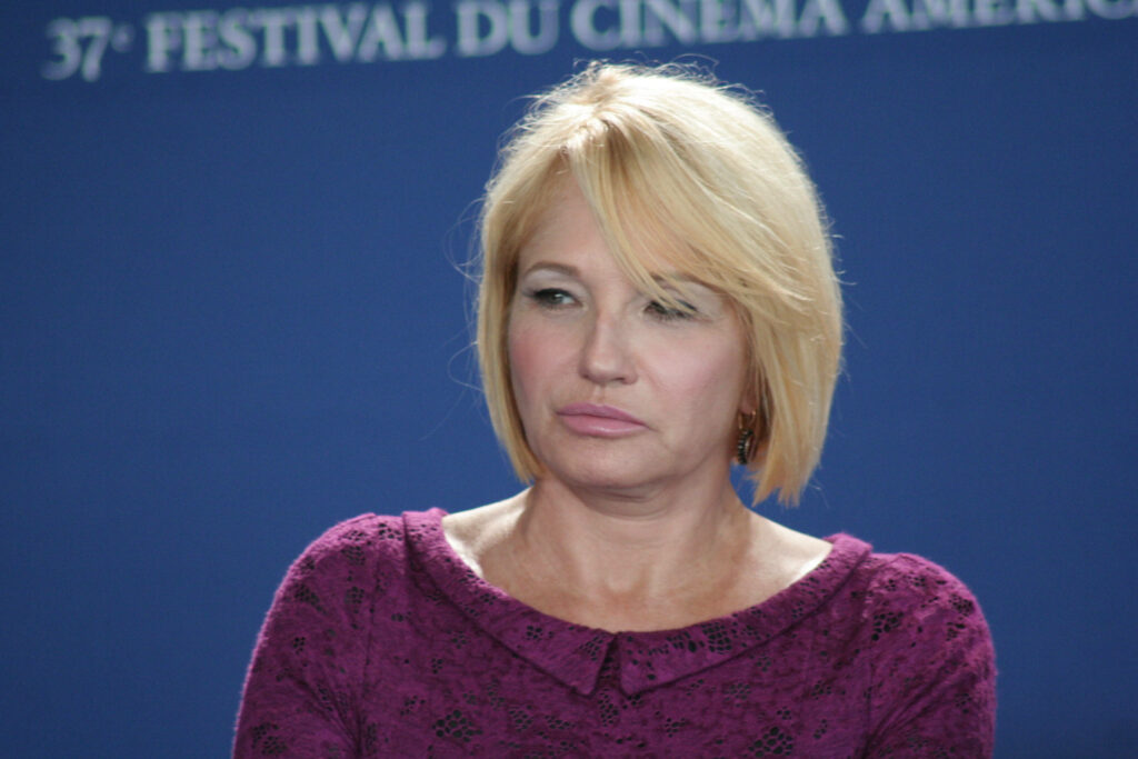 Ellen Barkin portrait wallpaper blue backdrop festival text purple textured top casual chic style