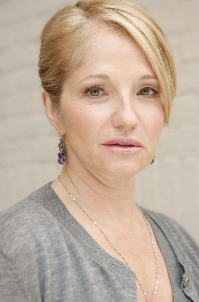 Ellen Barkin elegant portrait with soft natural light and sophisticated jewelry on neutral background Wallpaper