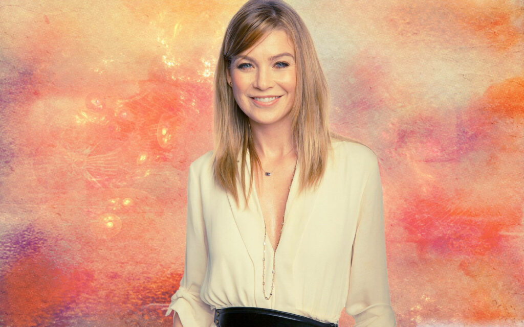 Ellen Pompeo smiling warmly in pastel pink orange beige background modern portrait wallpaper