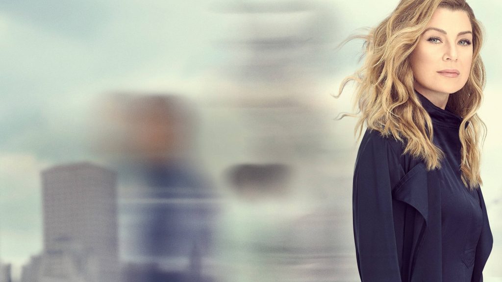 Ellen Pompeo as Meredith Grey with wavy blonde hair and dark coat urban blurred background wallpaper