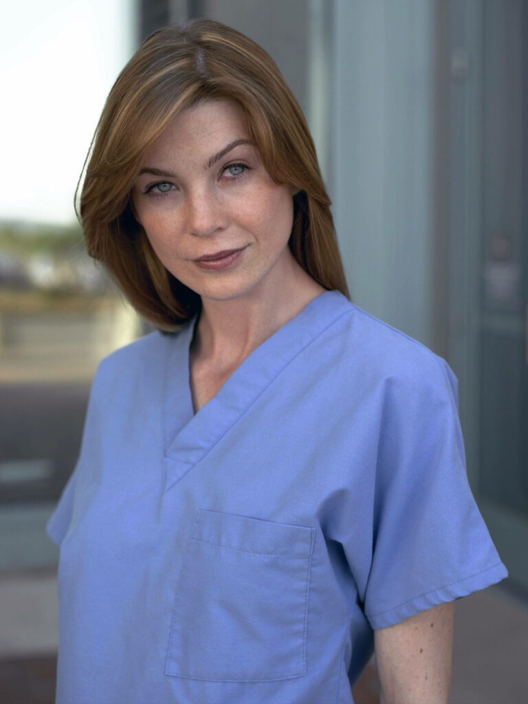 Ellen Pompeo in blue medical scrubs sharp focus natural light realistic professional wallpaper background