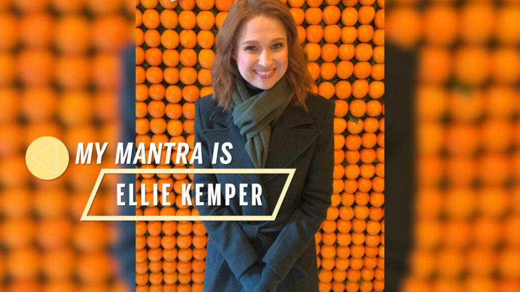 Ellie Kemper smiling against bold orange pattern with My Mantra is Ellie Kemper text wallpaper