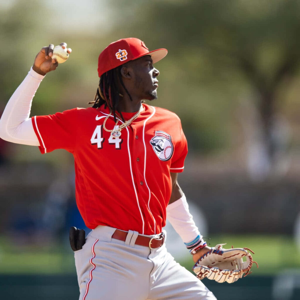 Elly De La Cruz in red uniform number 44 batting on baseball field dynamic sports action Wallpaper