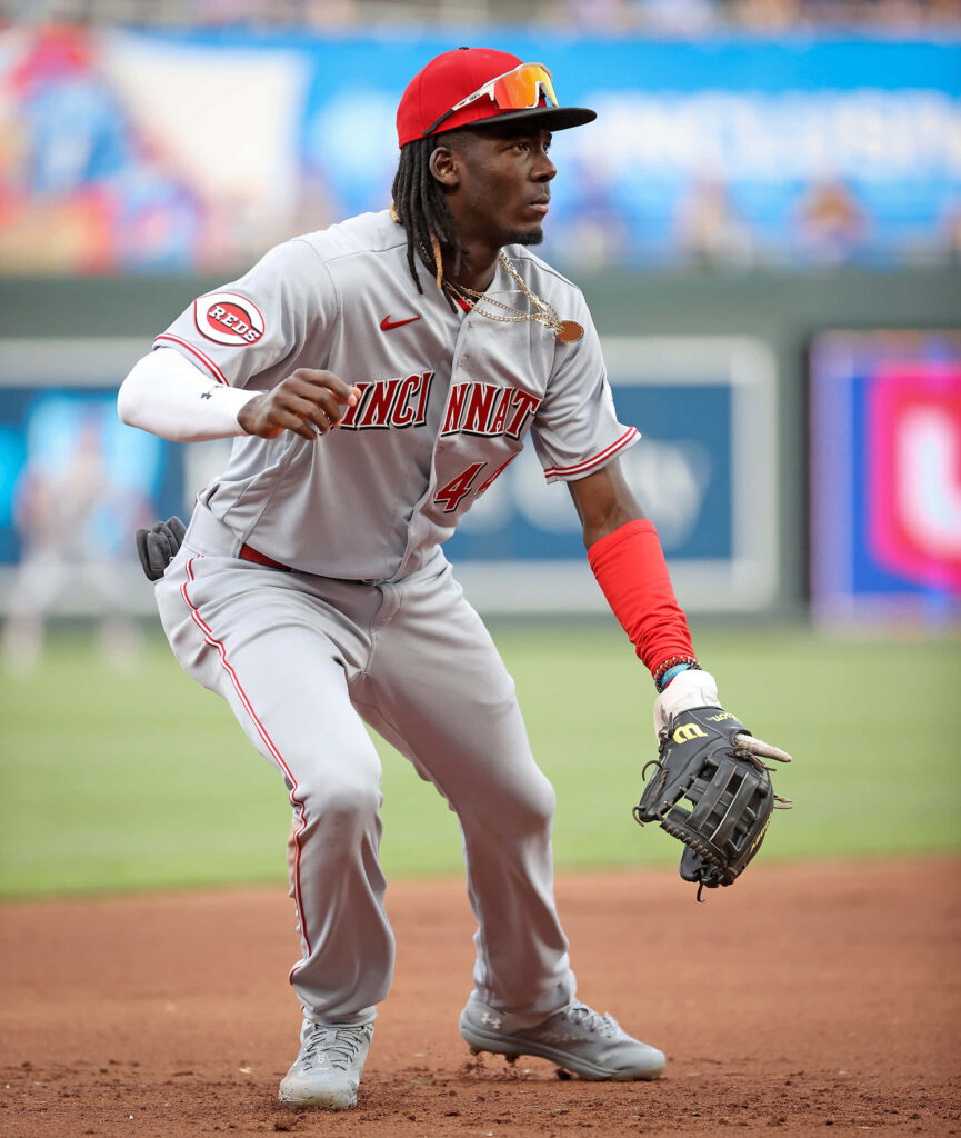 Elly De La Cruz Cincinnati Reds in gray red uniform action shot on baseball field wallpaper background