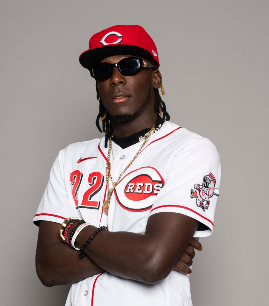 Elly De La Cruz Cincinnati Reds player posing in jersey sunglasses and gold chains wallpaper
