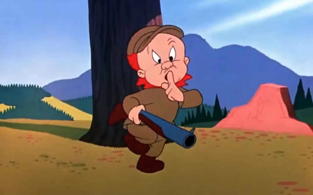 Elmer Fudd in colorful cartoon forest holding shotgun with finger to lips signaling silence wallpaper