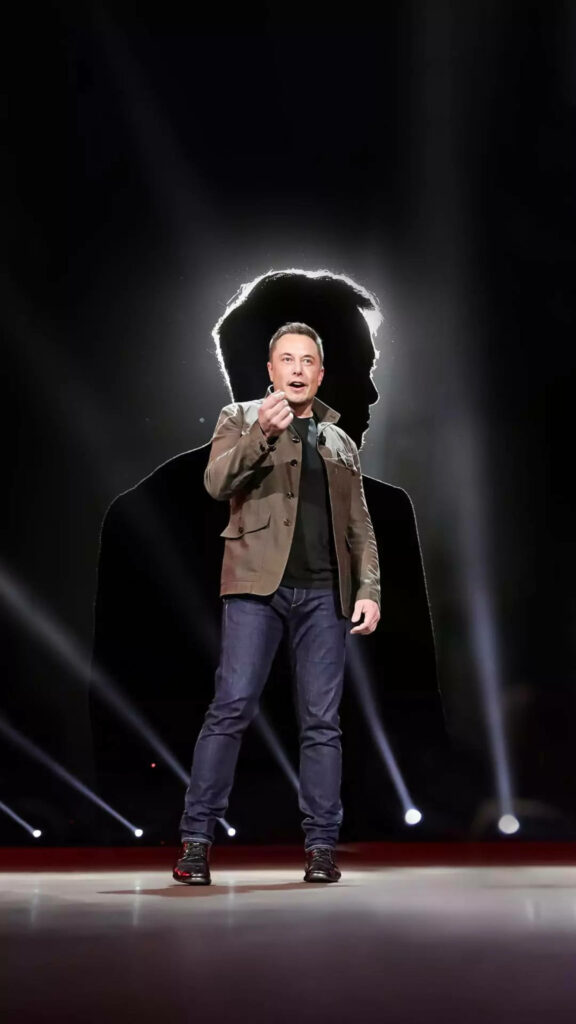 Elon Musk Wallpaper: Striking Stage Silhouette with Dramatic Lighting