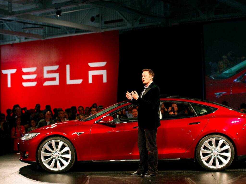 Elon Musk at Tesla Event: Sleek Model 3 Wallpaper Background