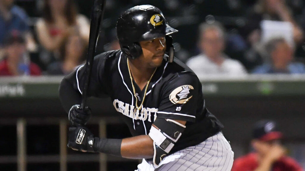 Eloy Jiménez batting in Charlotte uniform intense focus powerful stance baseball wallpaper background