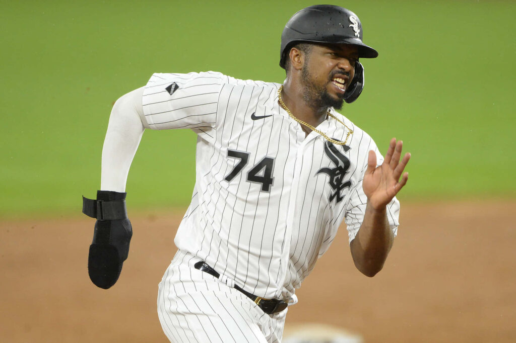 Eloy Jiménez in Chicago White Sox pinstripe uniform sprinting during intense baseball game action Wallpaper
