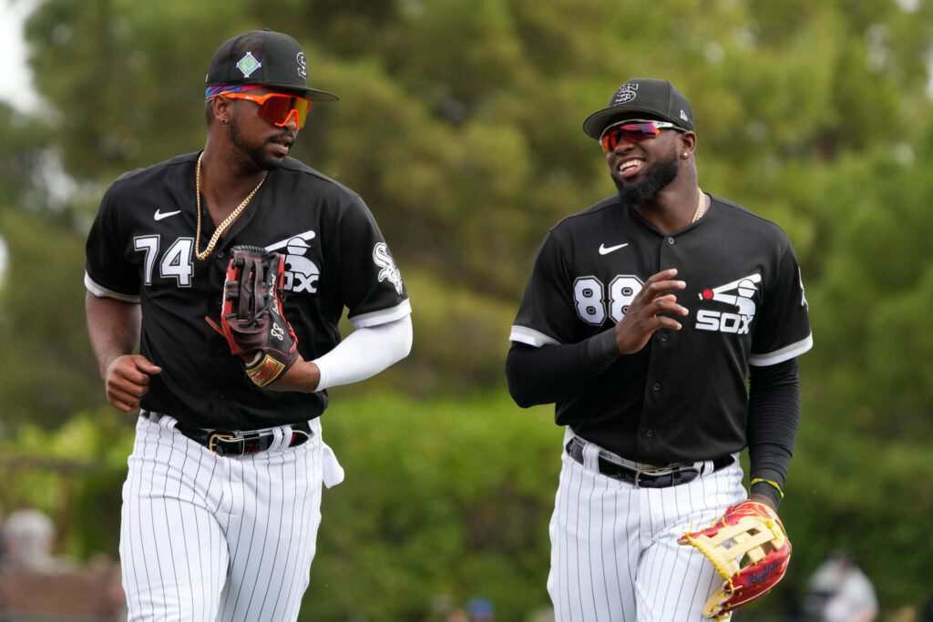Eloy Jiménez and Luis Robert Jr. Chicago White Sox spring training black jerseys white pants outdoors Wallpaper