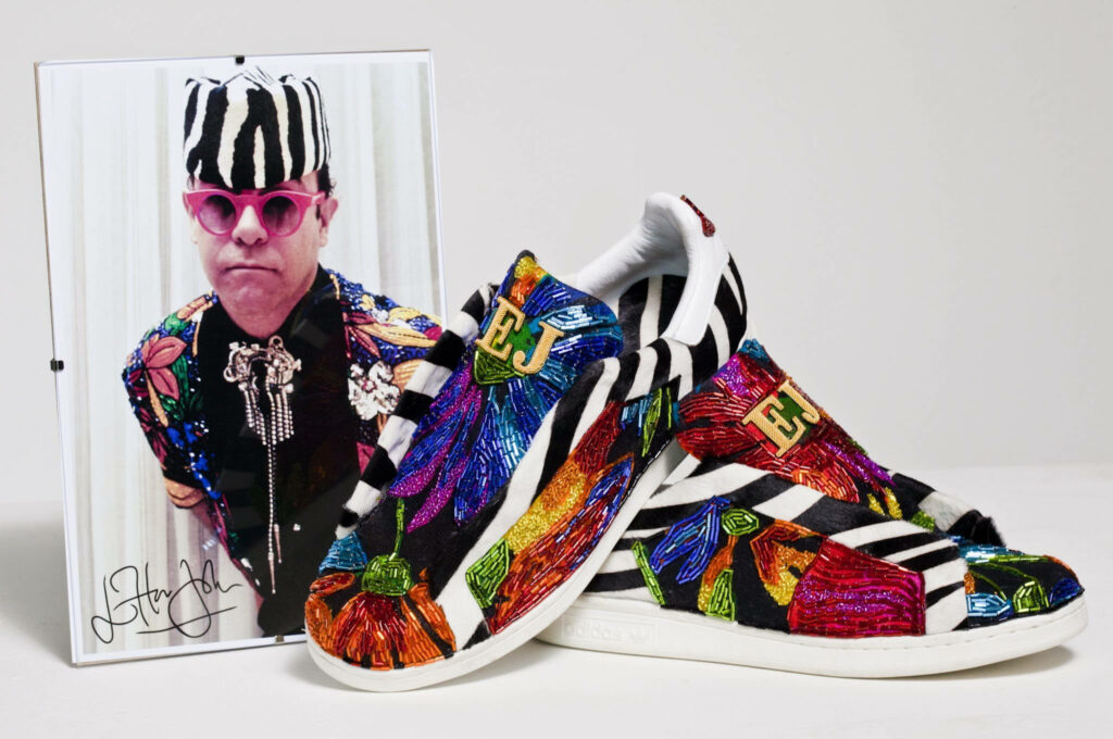 Elton John wallpaper with colorful embroidered EJ sneakers zebra patterns and vibrant portrait