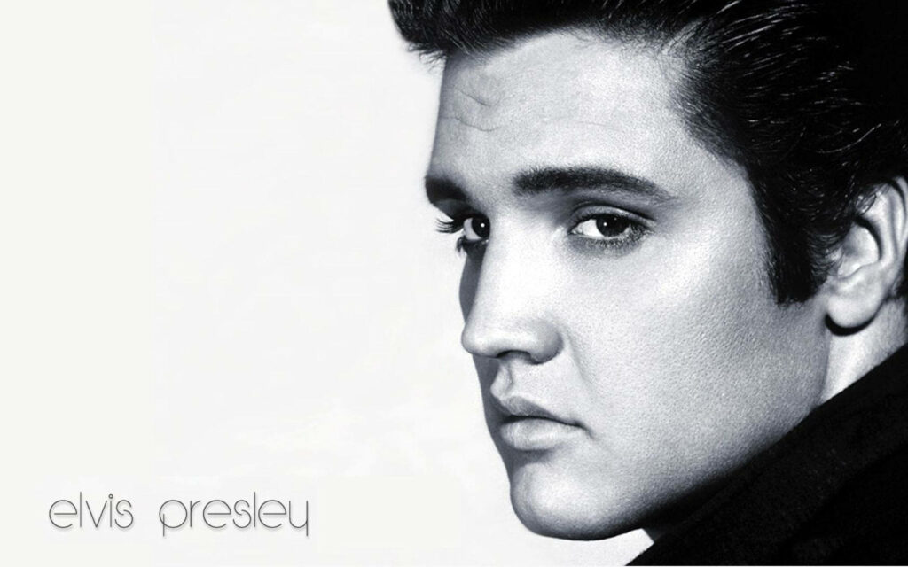 Monochrome side profile of Elvis Presley with iconic hairstyle black and white wallpaper background