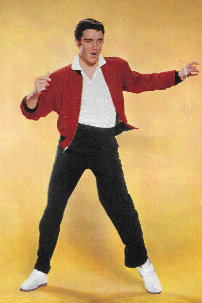 Elvis Presley dynamic pose red jacket vibrant yellow background retro rock and roll wallpaper