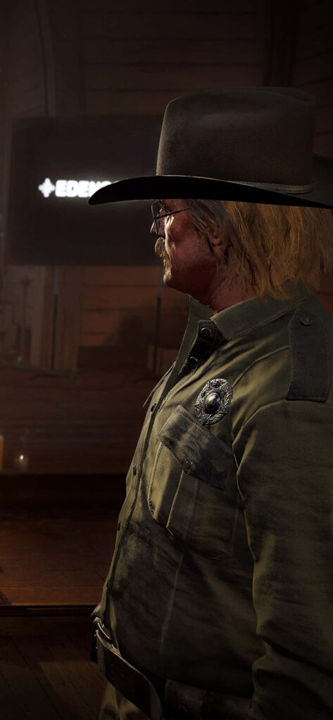 Far Cry 5 Wallpaper: Mysterious Figure with Silver Badge and Eden's Gate Symbol