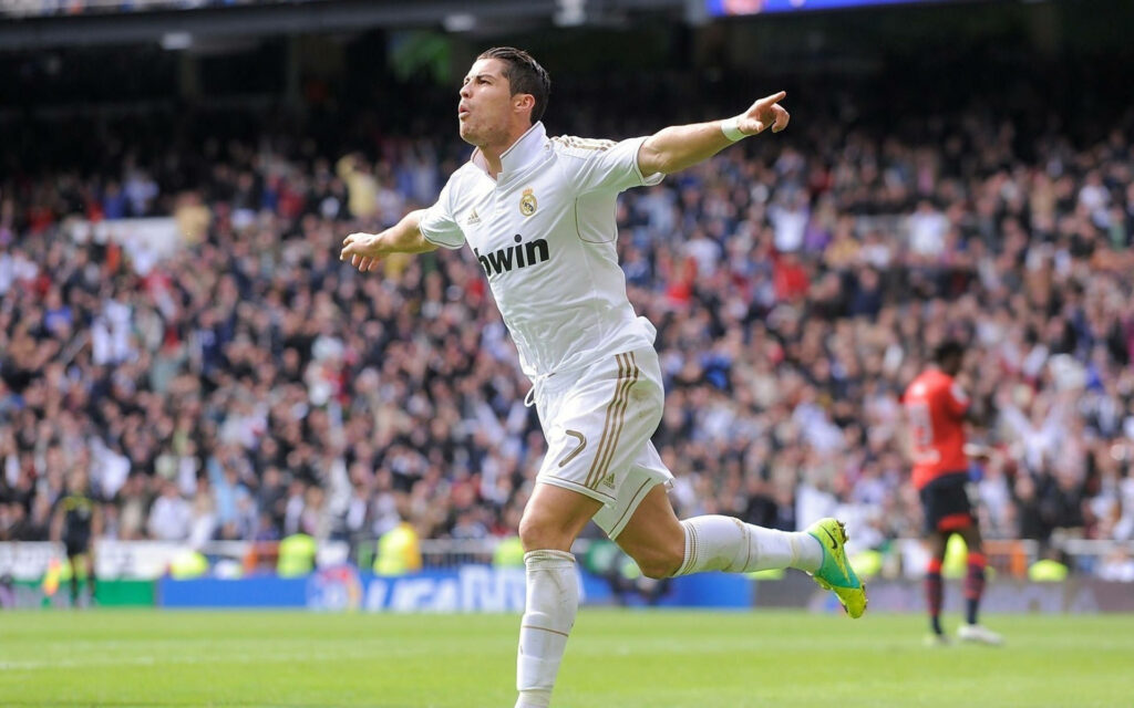 Cr7 Embracing the Field: Ronaldo's Iconic Run Surrounded by Enthusiastic Fans and Athletes Wallpaper