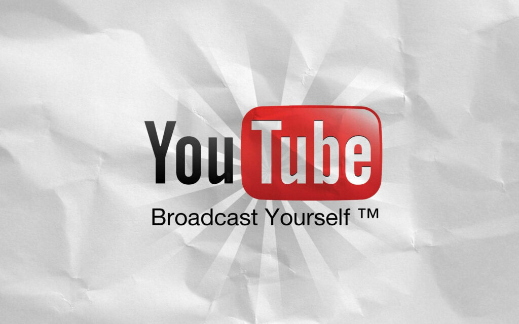 The Essence of YouTube: Unveiling the Signature Logo in Monochrome on Textured Paper Wallpaper