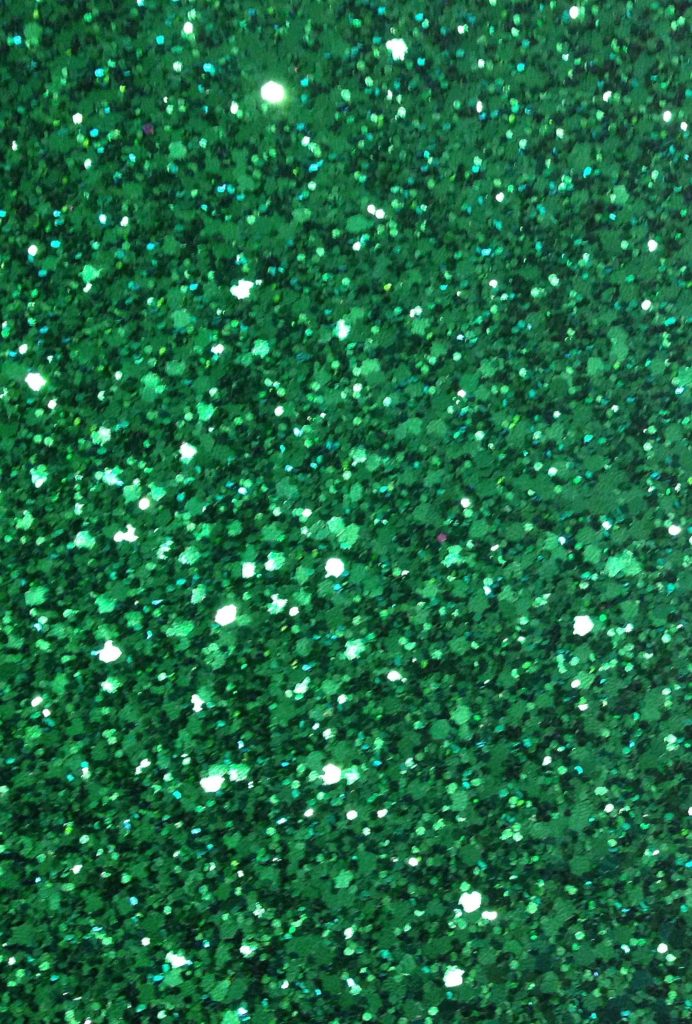 Emerald green glitter background with sparkling sequins and rich textured highlights wallpaper