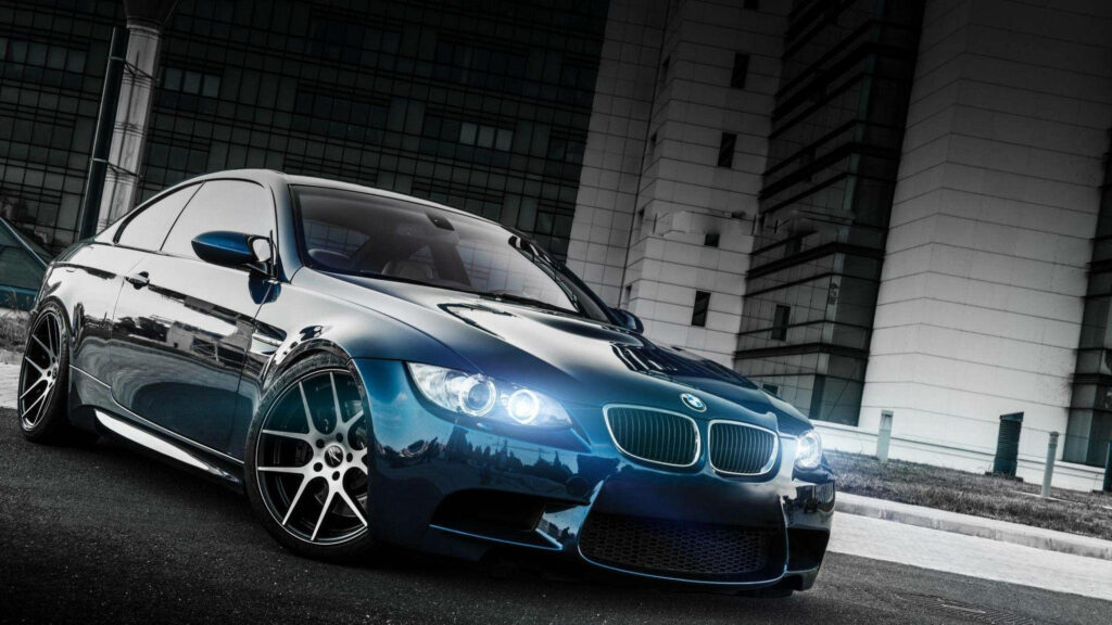 Blazing through the Night: Neon-lit BMW Races Across the Road Wallpaper