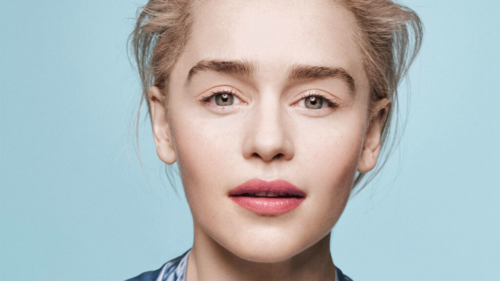 Emilia Clarke close-up portrait with soft blue background natural beauty gentle lighting Wallpaper