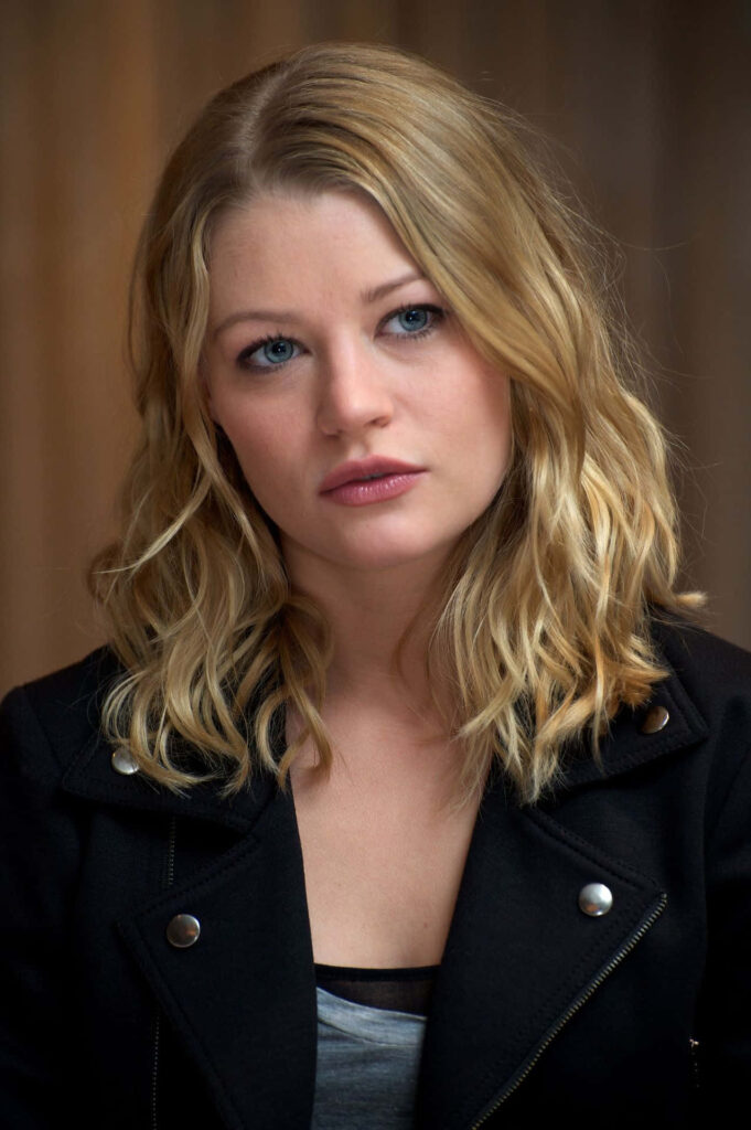 Close-up portrait of Emilie de Ravin with tousled blonde hair and expressive blue eyes in soft light Wallpaper