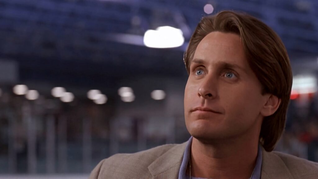 Close-up of Emilio Estevez in D2 The Mighty Ducks 1994 sports drama with ice rink background Wallpaper