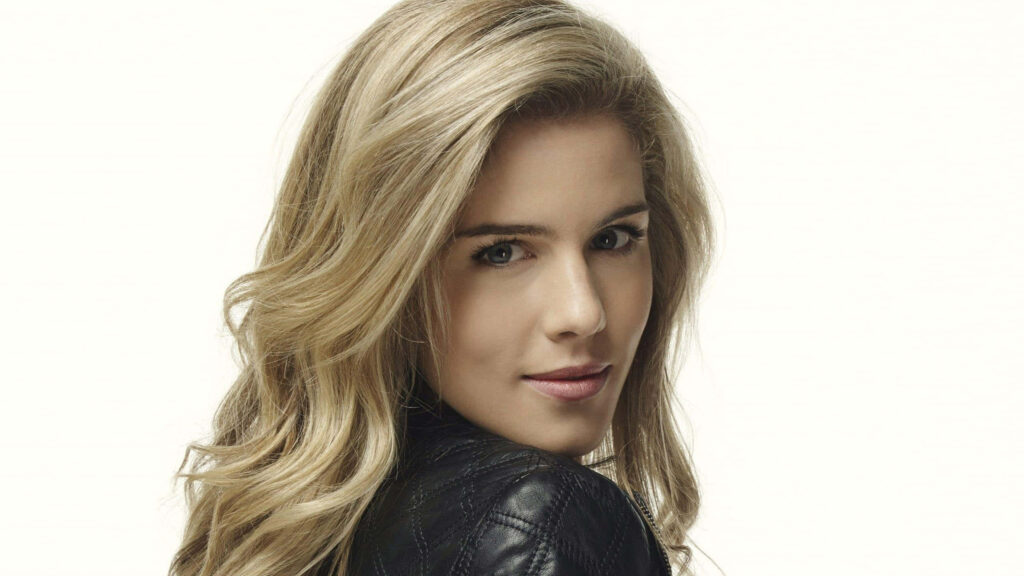 Emily Bett Rickards portrait with flowing blonde hair natural makeup and black leather jacket wallpaper