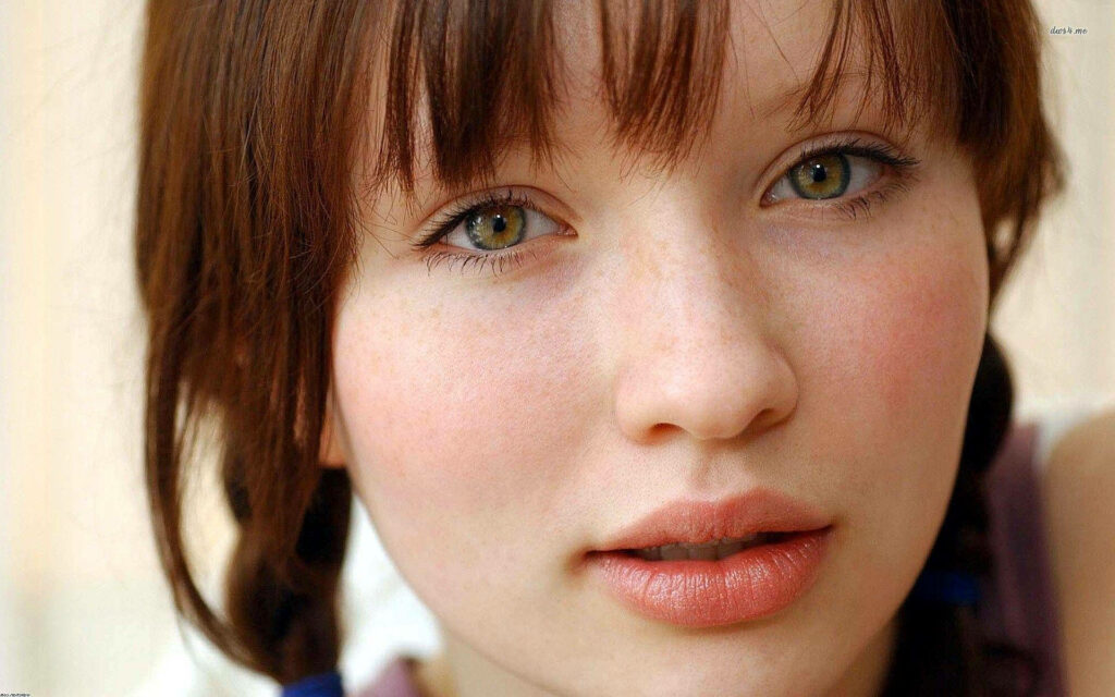 Close-up portrait of Emily Browning with soft lighting and neutral tones highlighting her eyes Wallpaper