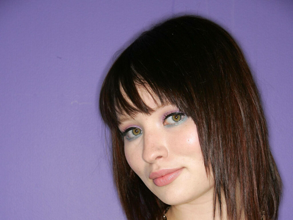 Australian actress Emily Browning with straight dark hair and soft makeup on purple background Wallpaper
