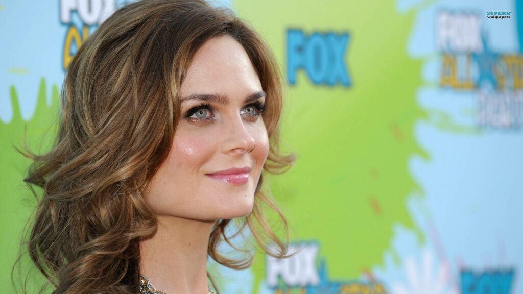 Emily Deschanel at Fox event with colorful green and blue backdrop elegant style and soft waves Wallpaper