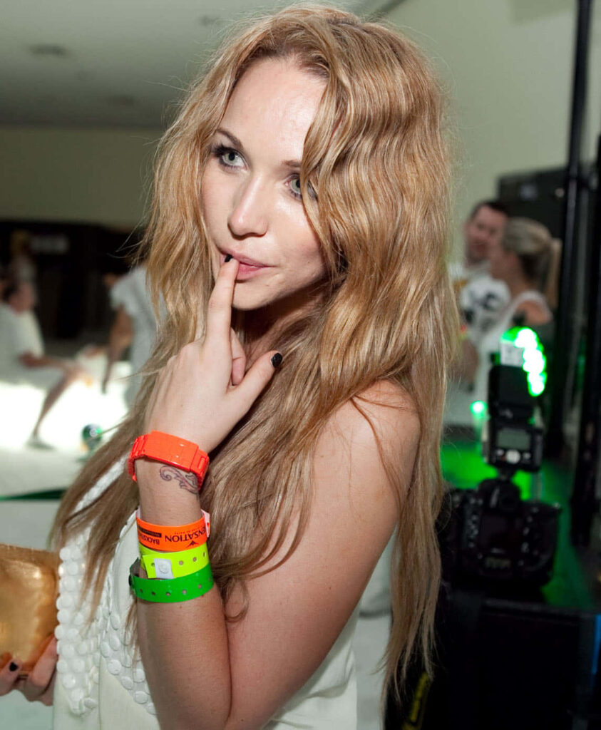 Emily Scott playful pose neon wristbands wavy blonde hair vibrant party wallpaper background