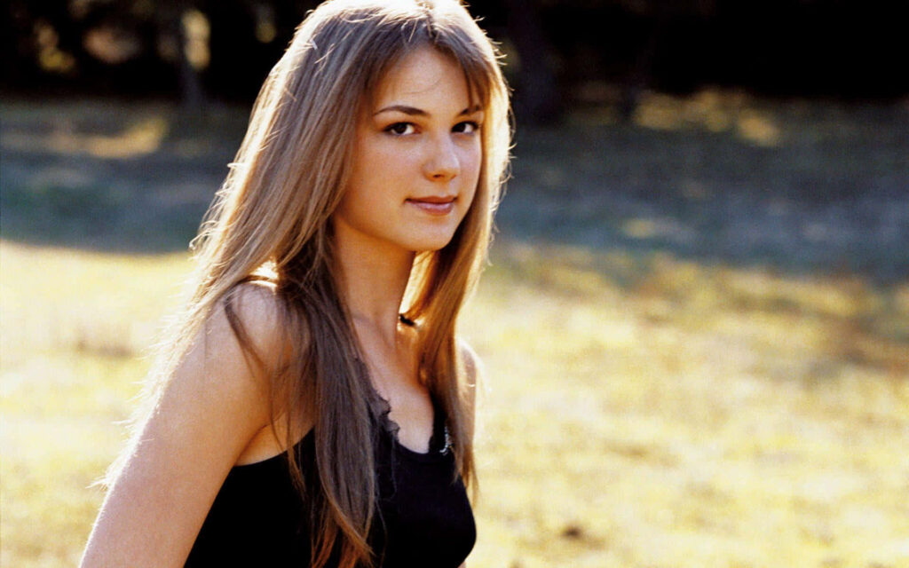 Emily VanCamp outdoor wallpaper with golden sunlight calm expression black tank top serene style