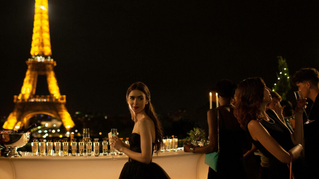 Emily in Paris rooftop party with illuminated Eiffel Tower glowing in Paris night sky wallpaper