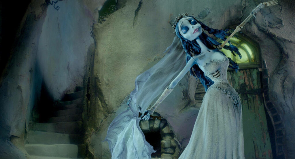 Emily the Corpse Bride dancing in tattered gown with gothic whimsical background wallpaper