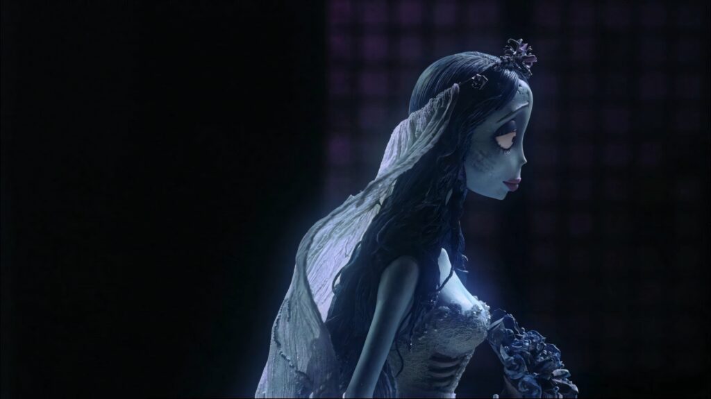 Emily the Corpse Bride side view with blue skin black hair wedding dress gothic wallpaper background