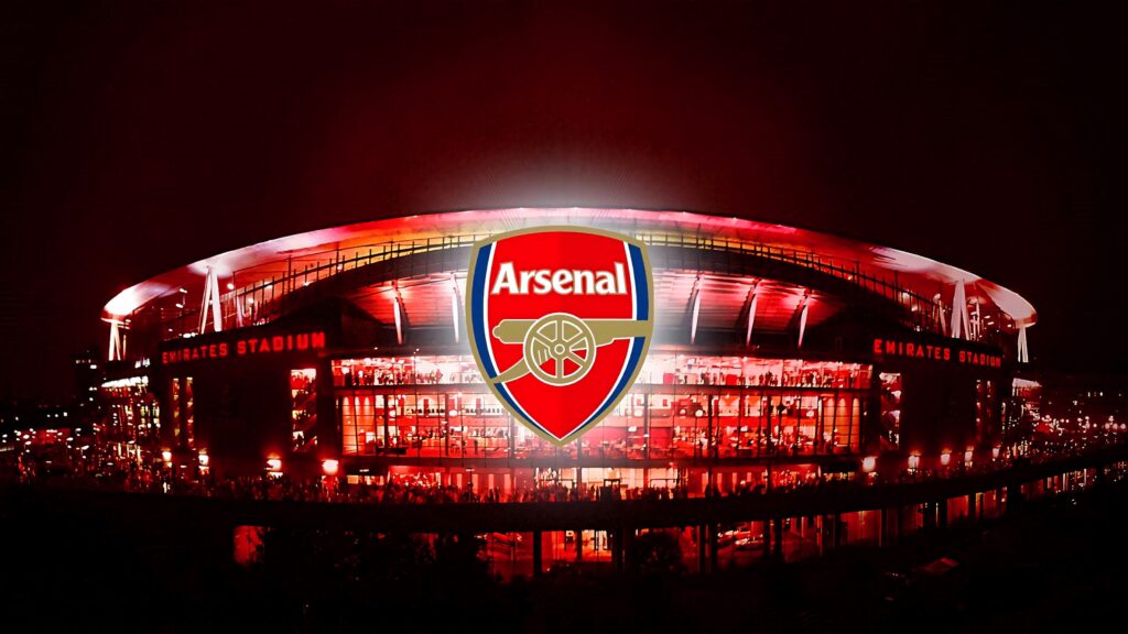 Emirates Stadium night view with bright lights and bold Arsenal FC logo wallpaper background