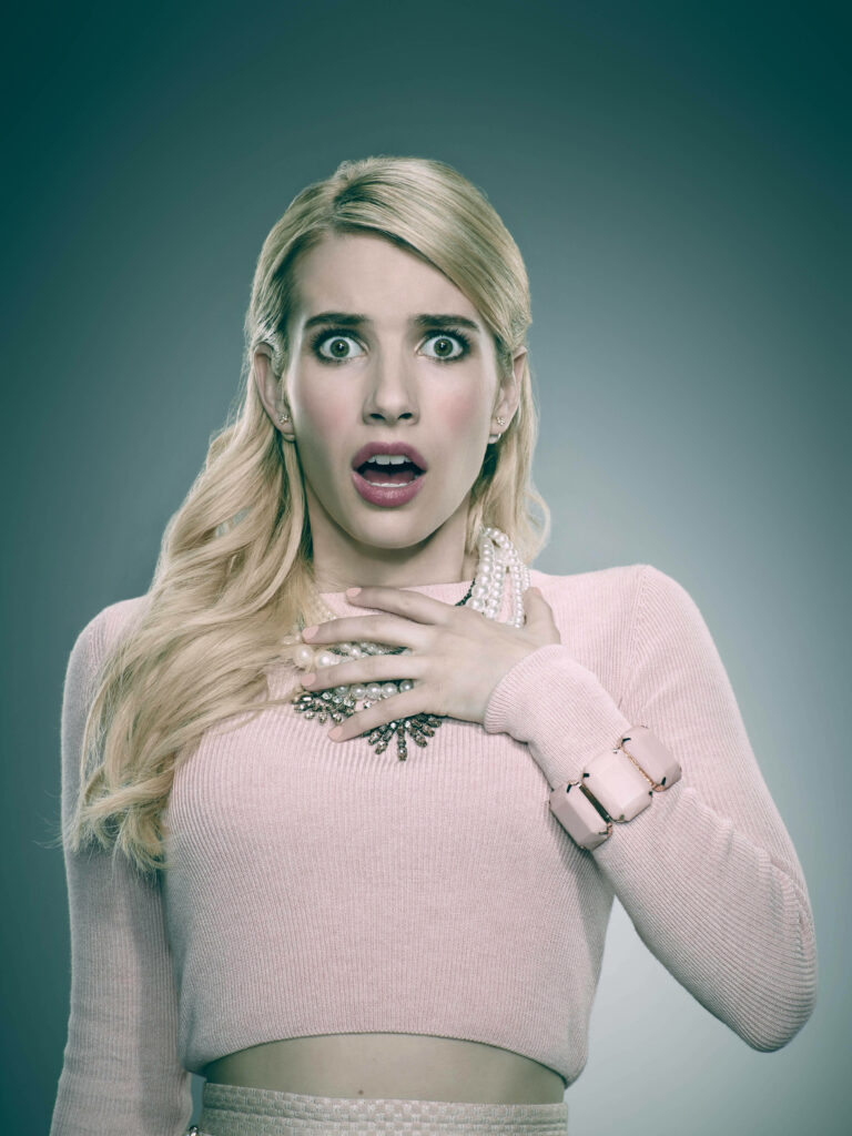 Emma Roberts shocked expression pastel pink outfit elegant jewelry portrait wallpaper background