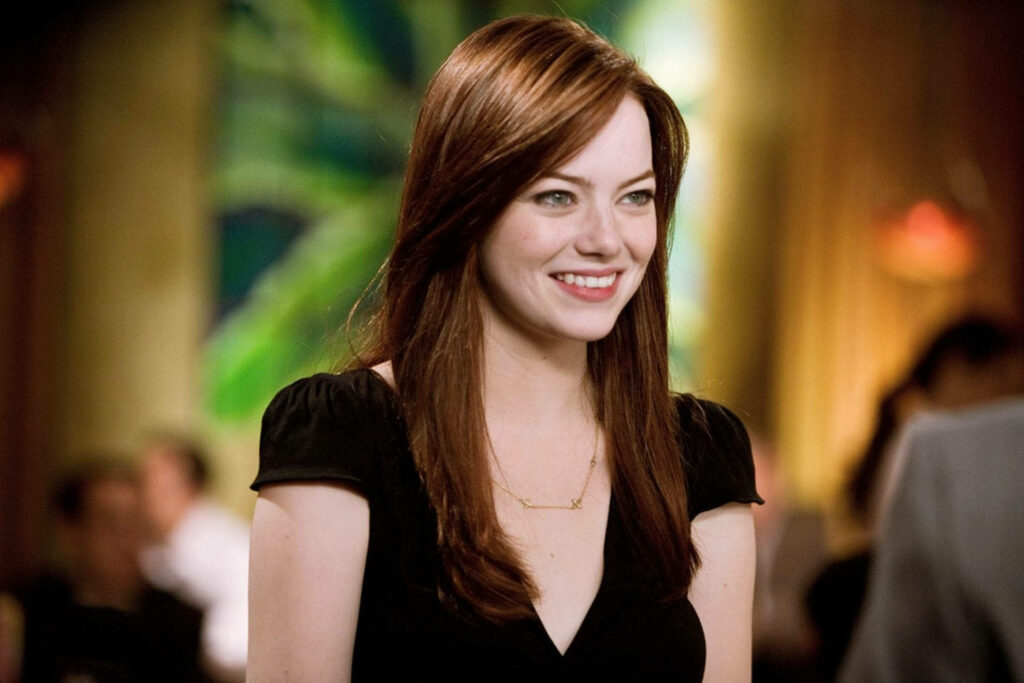 Emma Stone smiling warmly with colorful abstract background and soft ambient lighting wallpaper