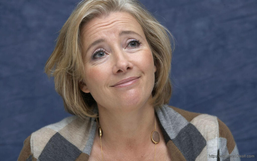 Emma Thompson portrait wallpaper in checkered cardigan with soft blue textured background