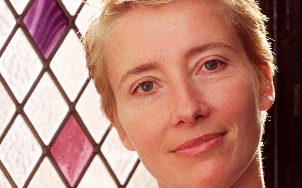 Emma Thompson close-up with serene expression and geometric stained glass background wallpaper