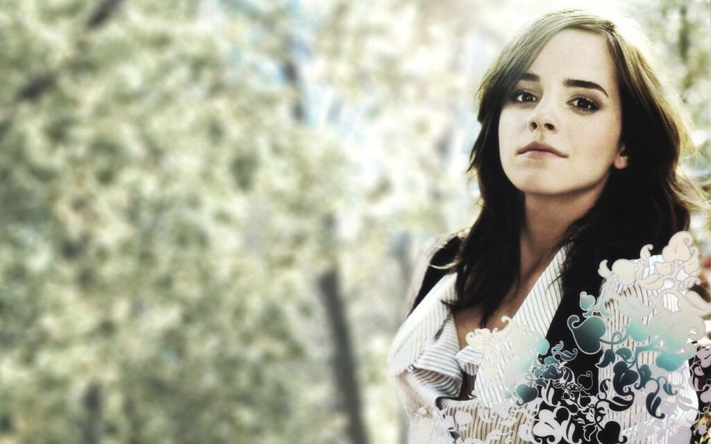 Emma Watson artistic wallpaper with expressive gaze soft blurred green nature background