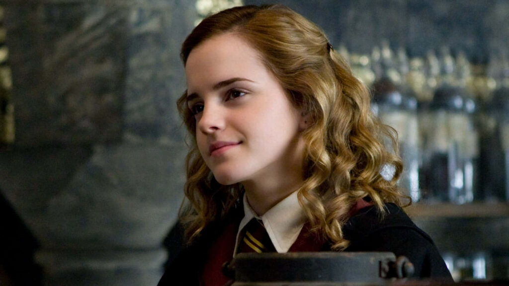 Emma Watson Hogwarts wallpaper with golden lighting wavy hair and magical Harry Potter vibe