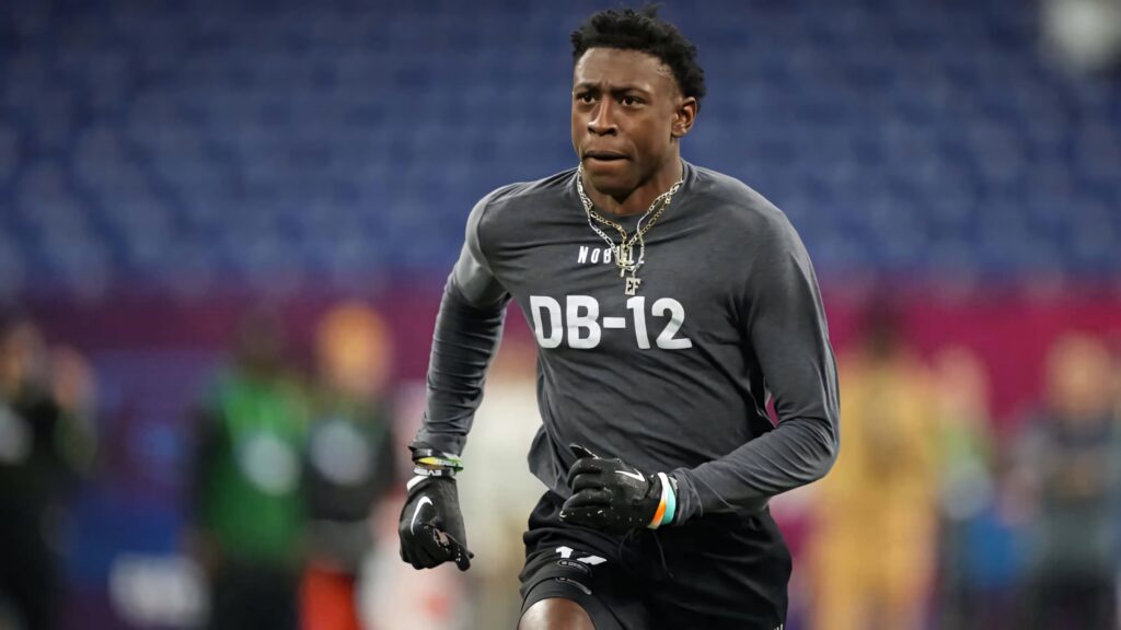 Emmanuel Forbes Jr. intense football combine training wearing dark DB-12 shirt in stadium Wallpaper
