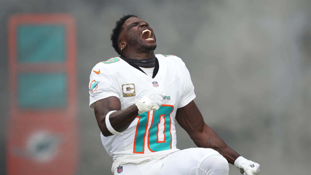 Emmanuel Forbes Jr celebrating intensely in white teal football uniform on vibrant game field background Wallpaper