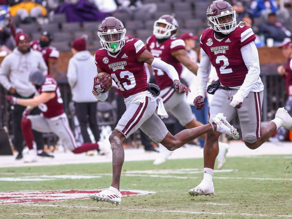 Emmanuel Forbes Jr running with football in Mississippi State game maroon white uniform action Wallpaper