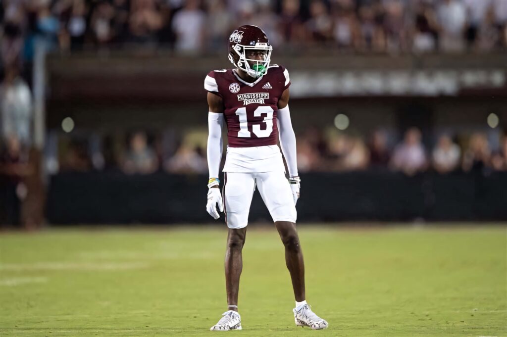 Emmanuel Forbes Jr in Mississippi State Football uniform number 13 focused in vibrant stadium background Wallpaper