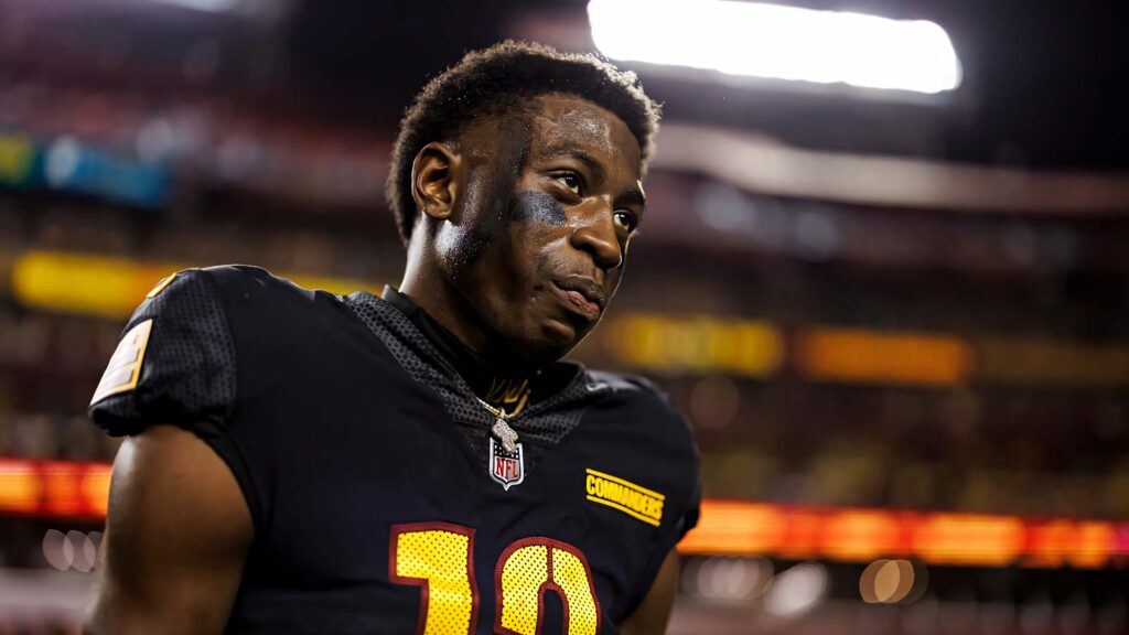 Emmanuel Forbes Jr in Number 10 jersey during vibrant evening football game under stadium lights Wallpaper