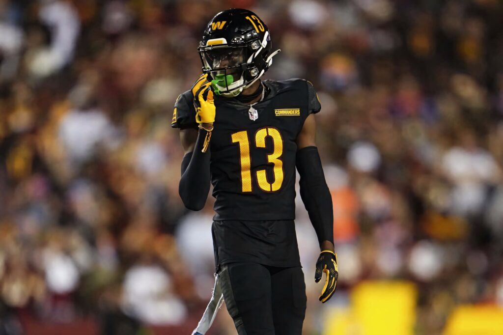 Emmanuel Forbes Jr number 13 in black and gold uniform mid-action on football field wallpaper