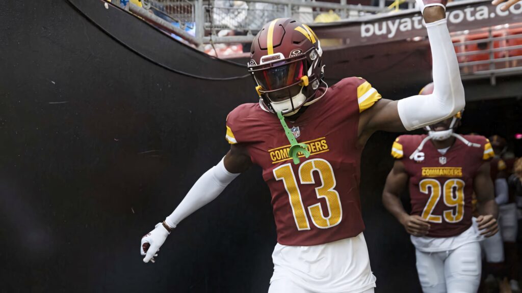 Emmanuel Forbes Jr in Washington Commanders jersey number 13 leading football team action shot Wallpaper