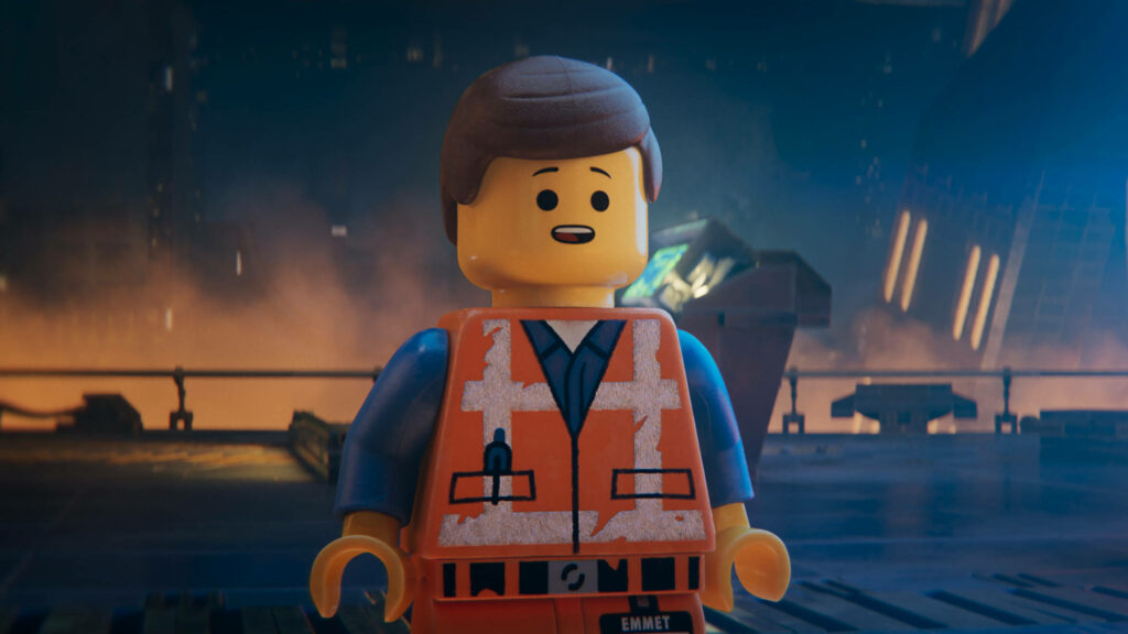 Emmet's Reflective Moment: Lego Movie Wallpaper in Dim Industrial Setting
